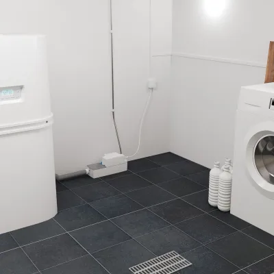 Атмосферное изображение Sanicondens Best Flat, насос конденсата, на полу рядом с котлом в прачечной.